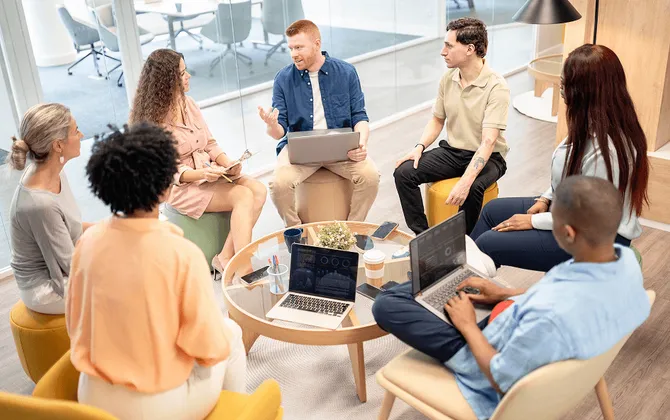 image d'illustration de la page "a propos" représente un groupe de personnes autoue d'une table ronde en train de travailler